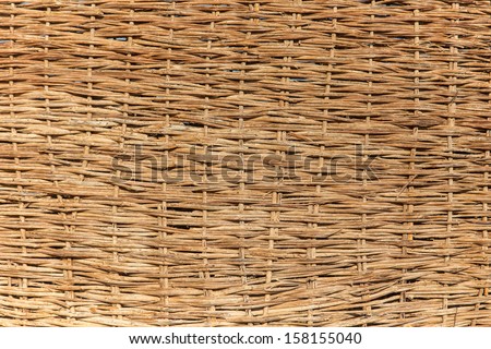 a woven willow wicker fence panel suitable for crafts, picnic or gardening background or wallpaper