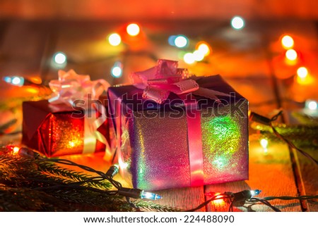 Set of Christmas gift boxes with light on wood.
