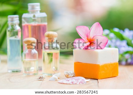 Spa treatment with scented candles and soap on wood.