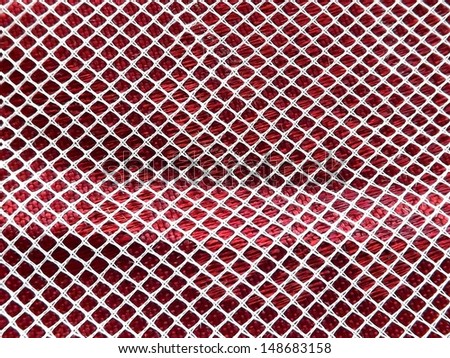 Macro view of sheer curtain fabric on red textured tablecloth