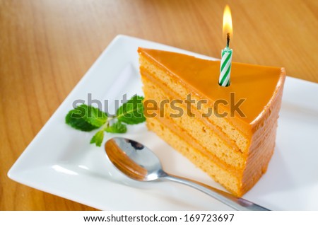 Dessert - happy birth day Cake with green candle, Focus at candle .