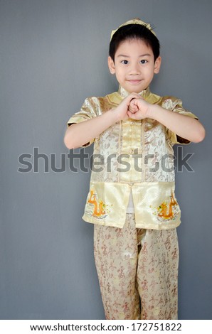 Oriental little boy wishing you a happy chinese new year