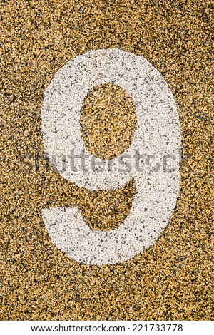 Number Nine sign on sand fome ,safety floor on playground.