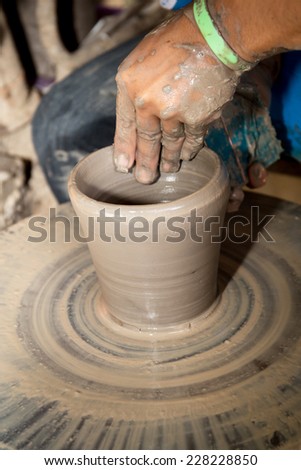 close up of Asian child hands and potter hand craft is training