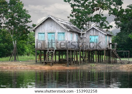 Wooden house on the river bank, Amazon River, rainy season, Brazil.