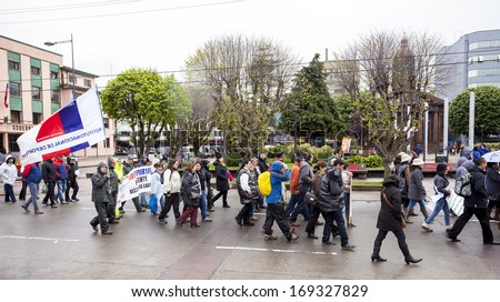 PUERTO MONTT, CHILE - November 14: Protesters during general strike. Government workers fighting for pensions, honor and justice, November 14, 2013 in Puerto Montt, Chile.