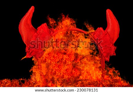 Devil party horns in fire, temptation or sin concept.