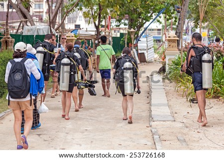 PHI PHI ISLAND, THAILAND - JANUARY 6, 2015: Divers walking back from diving trip. Phi Phi is one of the most popular islands and diving spots in Thailand.