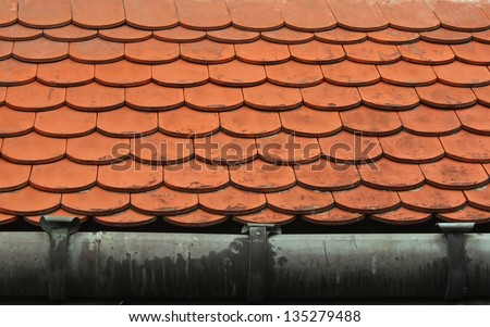traditional roof made of plain tiles with gutter