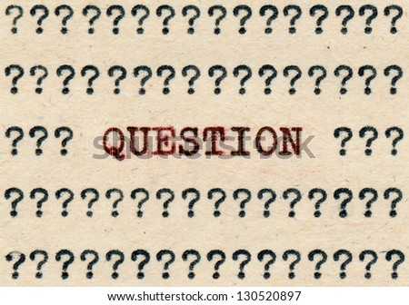 Question and question marks written with a typewriter on an aged paper.