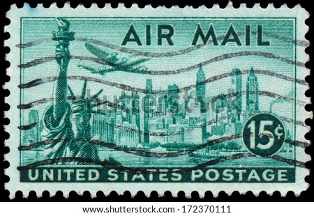 USA - CIRCA 1947: A stamp printed in United States of America shows Statue of Liberty on the background the skyscrapers of New York, airliner Lockheed Constellation, circa 1947