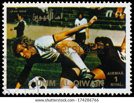 UMM AL-QUWAIN - CIRCA 1972: a stamp printed in the Umm al-Quwain shows image of a football player tackling another player, Summer Olympics, Munich 1972, circa 1972