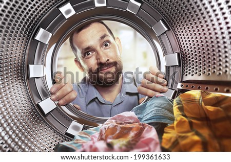 portrait of man view from washing machine inside