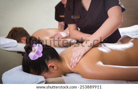 Beautiful young couple enjoy together a massage at spa centre