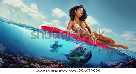 Vacation. Traveling. Woman hanging out on air mattress. With underwater part