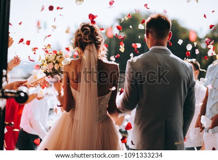 young couple in love.Wedding photo.Rose petals over a couple in love.Wedding ceremony with flowers 商業照片 © 