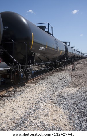Perspective of rail tanker cars on train tracks