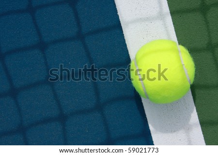 tennis ball on the out line of court