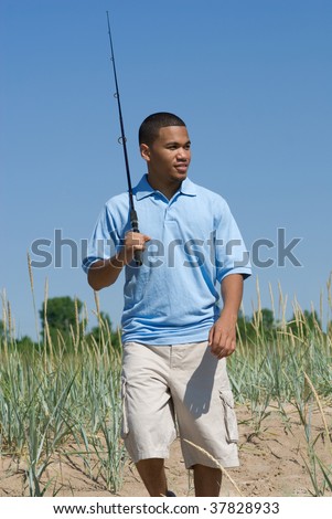 African American man walking on the beach to go fishing