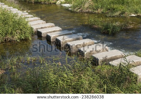 stepping stones cross over a stream in outdoor