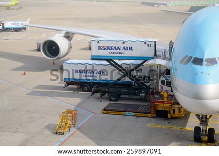 INCHEON, KOREA - JULY 29, 2013: Airplane of Korean Air, cargo is beding loaded.