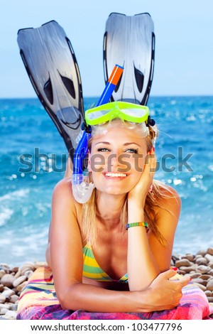 Beautiful woman having outdoor fun, female on the beach, happy teen girl wearing mask and fins, water sport, healthy young lady tanning and sunbathing, summer vacation, holidays travel