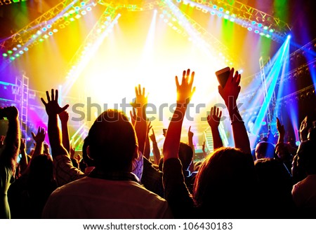 Rock concert, happy people silhouettes, raise up hands, disco party with large group of dancing man, bright colorful stage lights, active lifestyle, music entertainment, nightclub, night life concept