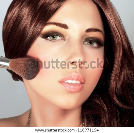 Picture of pretty woman with stylish makeup, cute girl holding brush for blush, sexy female with gloss brown hair, fashionable beauty salon, luxury lifestyle, perfect complexion, New Year party