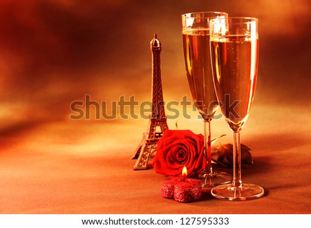 Picture of two glass of champagne on the table in restaurant, party dinner, wedding day, festive drink for Valentine day holiday, grunge background, fresh rose, Eiffel tower, love and romance concept