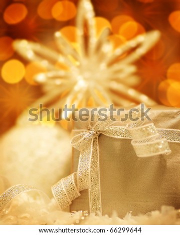 Winter holiday background with silver present gift box, star ornament & Christmas lights decoration