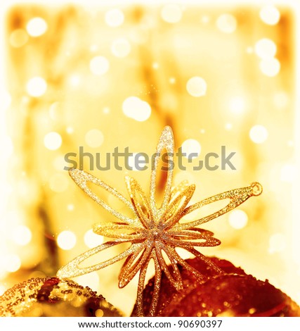 Christmas tree ornament and decoration as border, shining star with baubles, festive background card over abstract bokeh magic golden lights, winter holidays, with copy space