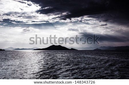 Beautiful night seascape, abstract natural background, dramatic cloudscape, island in moonlight, mysterious water landscape, magic night