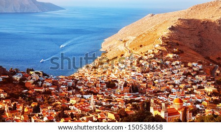 Beautiful coastal city, picturesque landscape, old European city, many little houses on seaside in Greece, summer holiday, travel and tourism concept