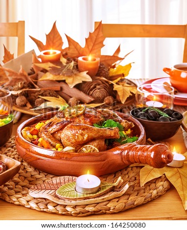 Tasty oven baked chicken on festive served table, Thanksgiving day, traditional autumn holiday, romantic dinner, delicious dish concept