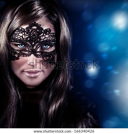 Closeup portrait of beautiful stylish woman wearing mask, luxury New Year party, masquerade in Christmas eve, beauty and fashion concept