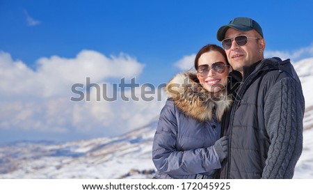Happy travelers enjoying snowy mountains, active lifestyle, winter season, beautiful nature, love and romance, wintertime vacation concept