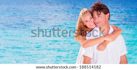 Happy couple on the beach, young family in love spending honeymoon vacation on luxury islands, cheerful active young people having fun at summertime travels, joy of life concept