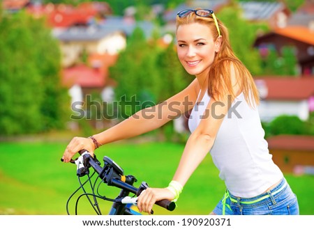 Portrait of happy woman resting in countryside, enjoying European tour on bicycle, extreme sport, happy summer holidays concept