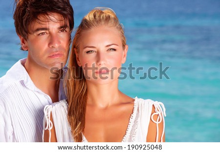 Closeup portrait of two serious young people spending summer holidays on the sea, young family in romantic vacation