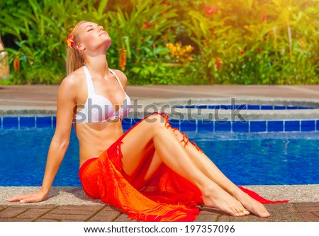 Female enjoying summer holidays, woman on day spa relaxation, sexy girl sunbathing near pool, luxury vacation on tropical resort, travel the world concept