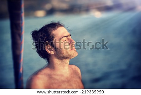 Closeup portrait of handsome man with closed eyes enjoying nature, summer adventure, travel and tourism concept