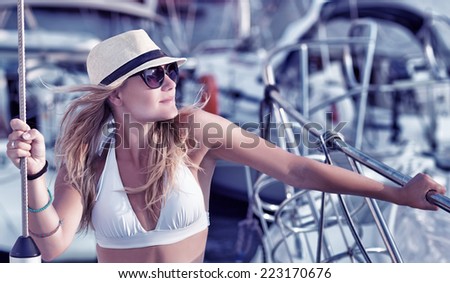 Portrait of attractive sexy woman tanning on the yacht, enjoying summer vacation in luxury sea cruise, freedom and enjoyment concept