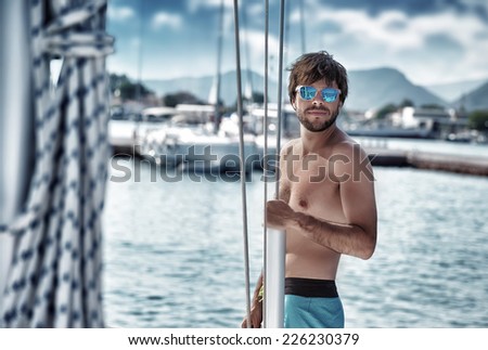Sexy man on sailboat, relaxation in luxury sea cruise, summertime leisure time on water transport, freedom and enjoyment concept