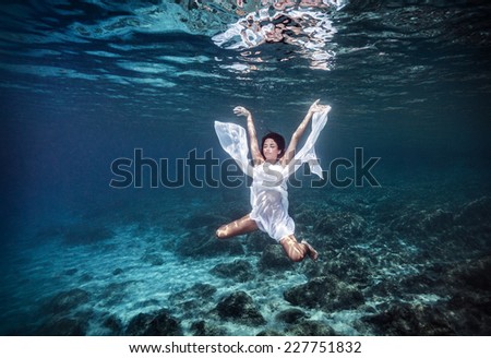 Underwater angel, aqua dance, diving to the beautiful sea bottom, summer vacation, active lifestyle, peace and harmony concept
