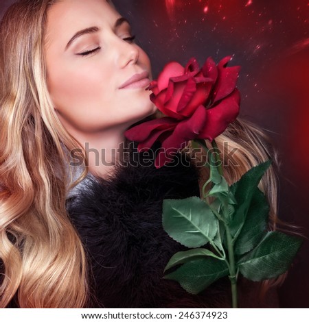 Closeup portrait of beautiful blond woman with closed eyes smelling fresh rose on dark red background, enjoying romantic holiday, happy Valentine day concept