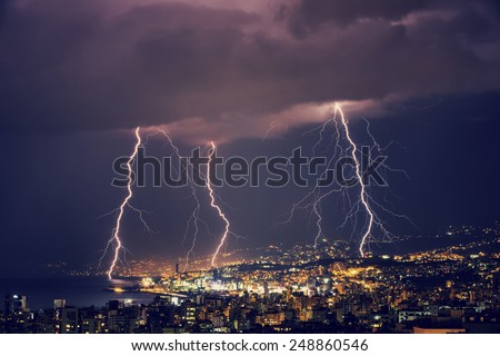 Beautiful lightning at night over gorgeous glowing Lebanon, majestic nighttime cityscape, stormy weather