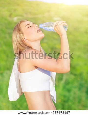 Happy tired woman drink water after workout in the park, enjoying training outdoors in sunny day, sportive and healthy lifestyle
