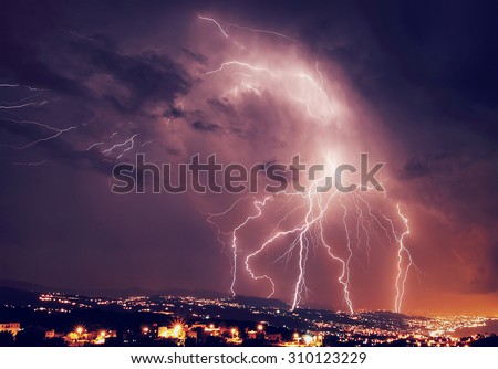 Beautiful lightning over night city, amazing nighttime panorama, powerful bright zipper, stormy weather, power of nature concept