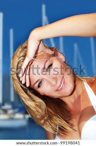 Woman enjoying sailing trip, close-up portrait on happy smiling female face, summer cruise holidays, European girl tourist traveling in sail boat around the world