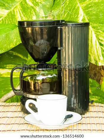 coffee cup and coffee machine on the garden background